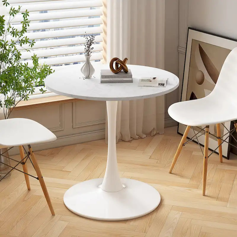 Tavolo da pranzo moderno con piano rotondo e base in metallo