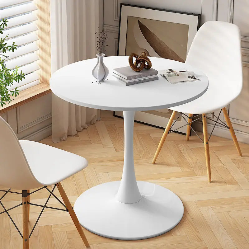 Tavolo da pranzo moderno con piano rotondo e base in metallo