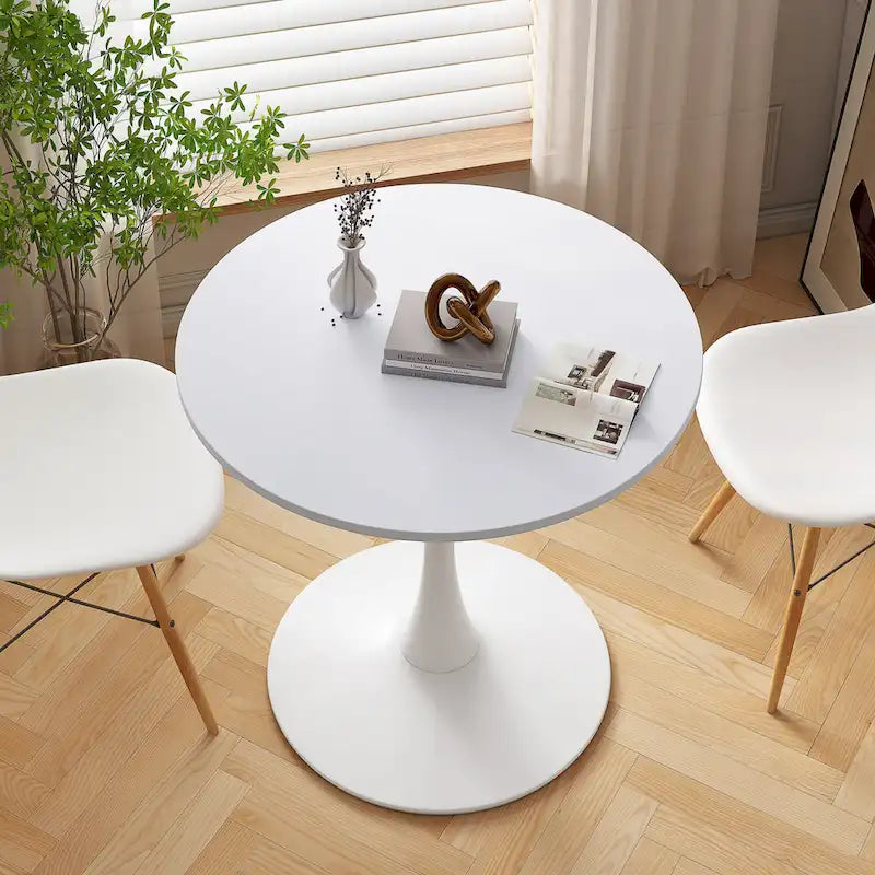 Tavolo da pranzo moderno con piano rotondo e base in metallo